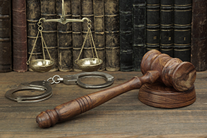 Scales of justice, gavel and handcuffs