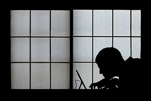 silhouette of a man at a computer